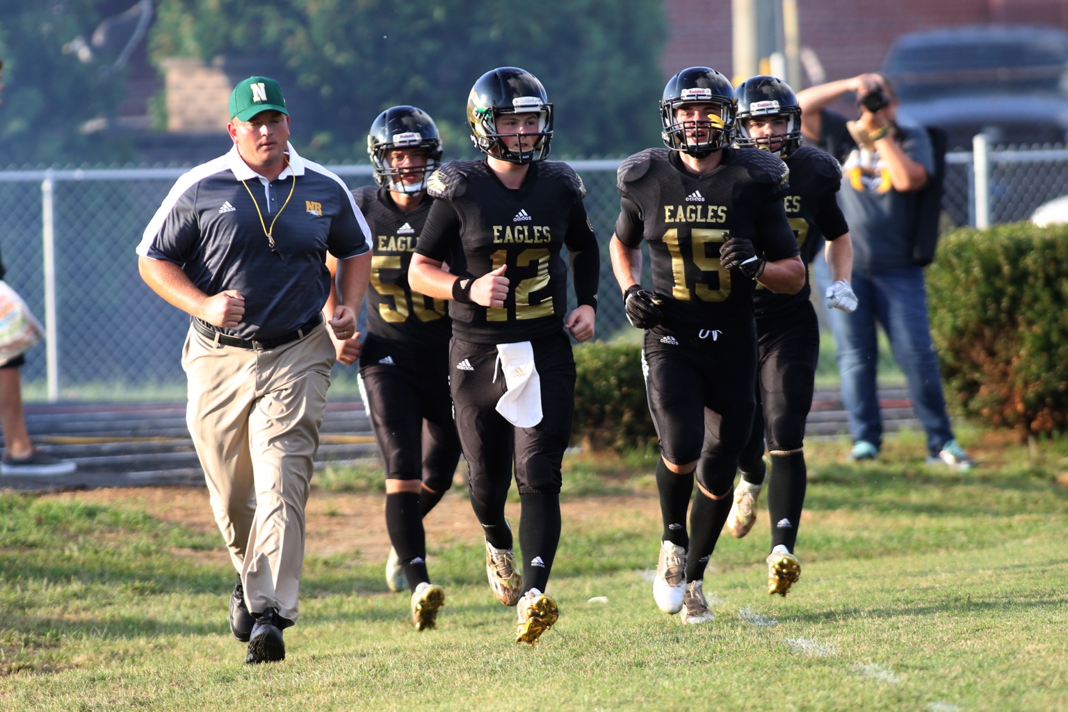 Adam Billings running onto the field with the North Bullitt Eagles